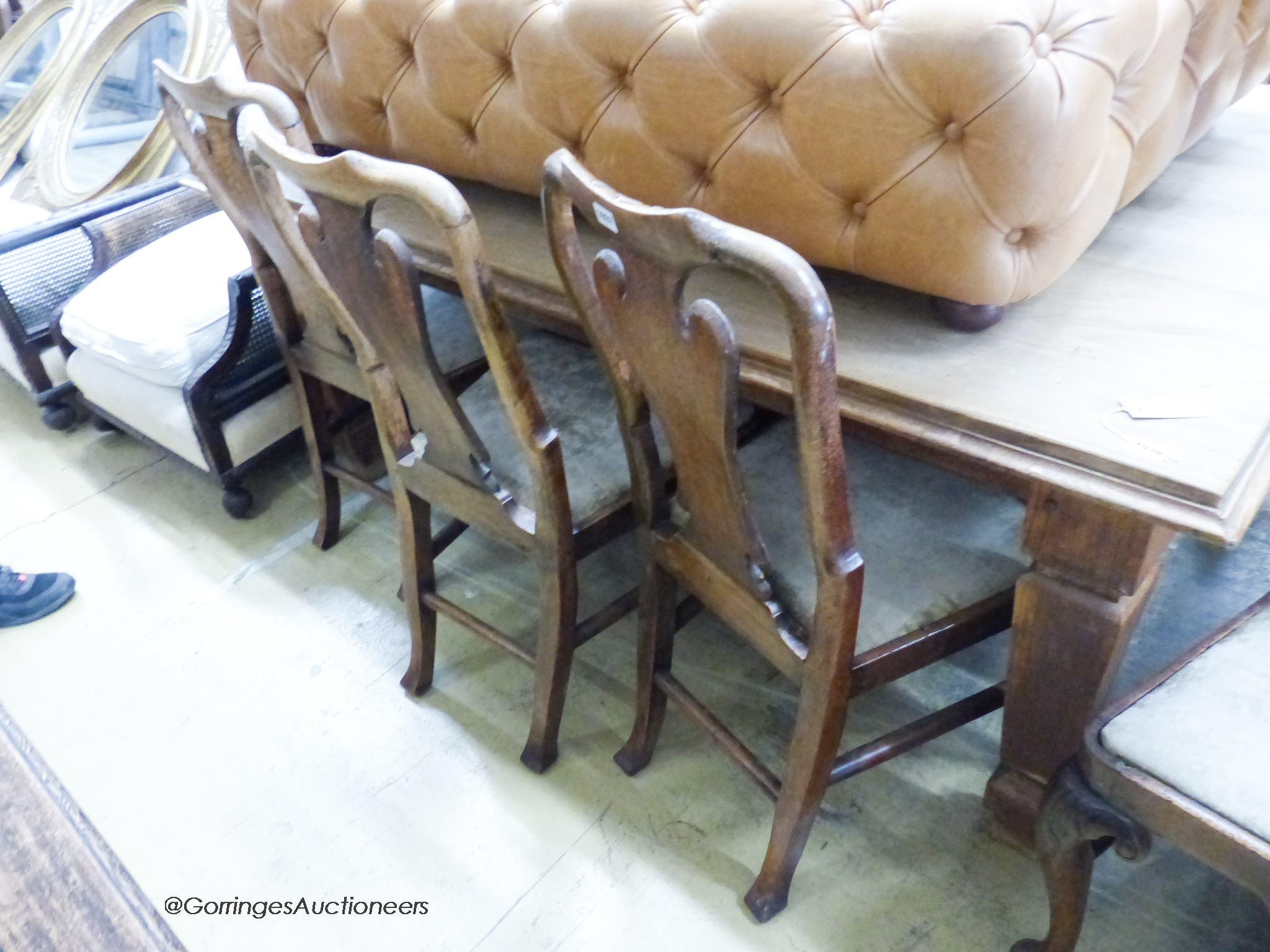 A set of four George I walnut dining chairs on front cabriole legs